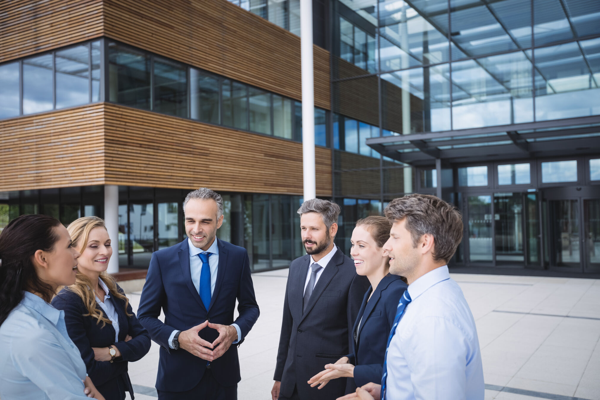 Group of businesspeople interacting outside office building